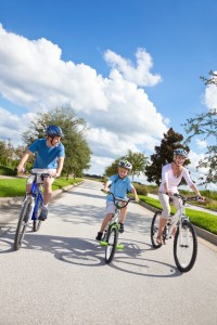 Young Family Parents and Boy Son Cycling